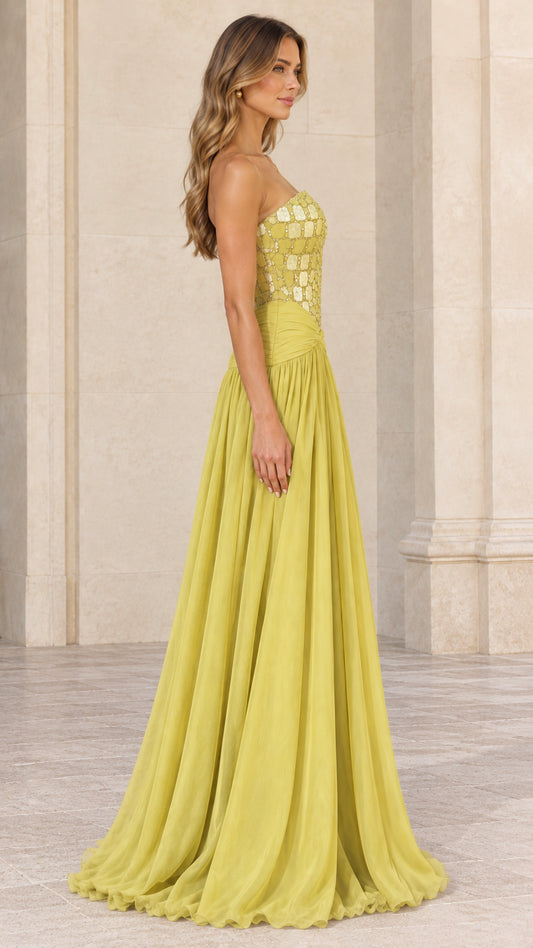 Side profile view of chartreuse strapless chiffon formal dress