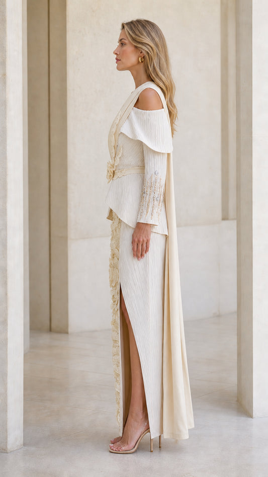 Side profile view of champagne evening gown showing cascading shoulder sash and slit