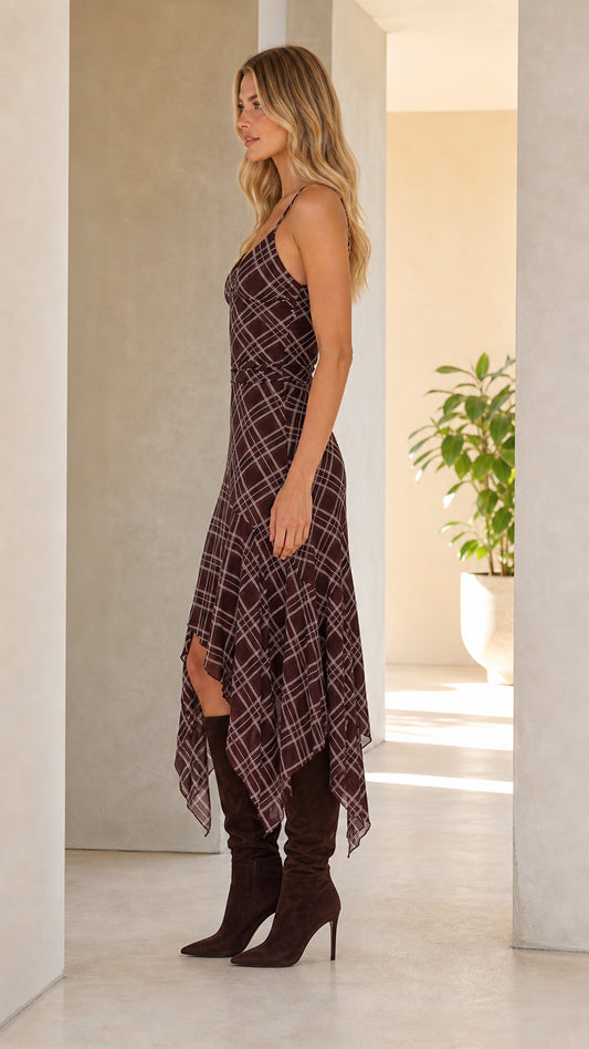 Side profile view of woman wearing brown plaid midi dress