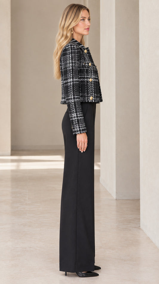 Side profile view of black plaid cropped tweed blazer styled with wide-leg trousers