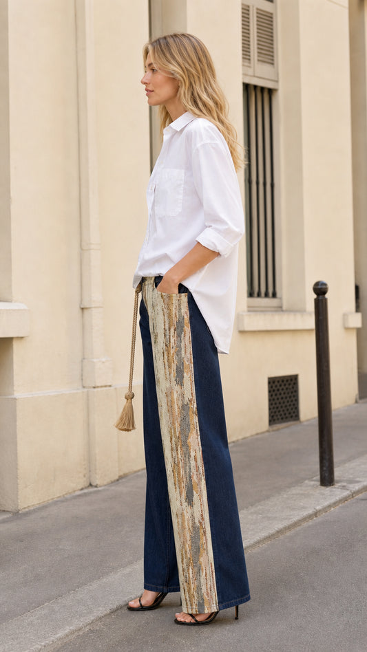 Side profile of model wearing spliced contrast wide leg denim trousers