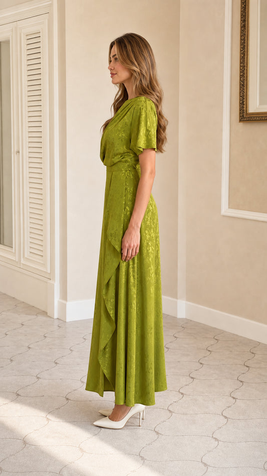 Side profile view of green draped maxi dress