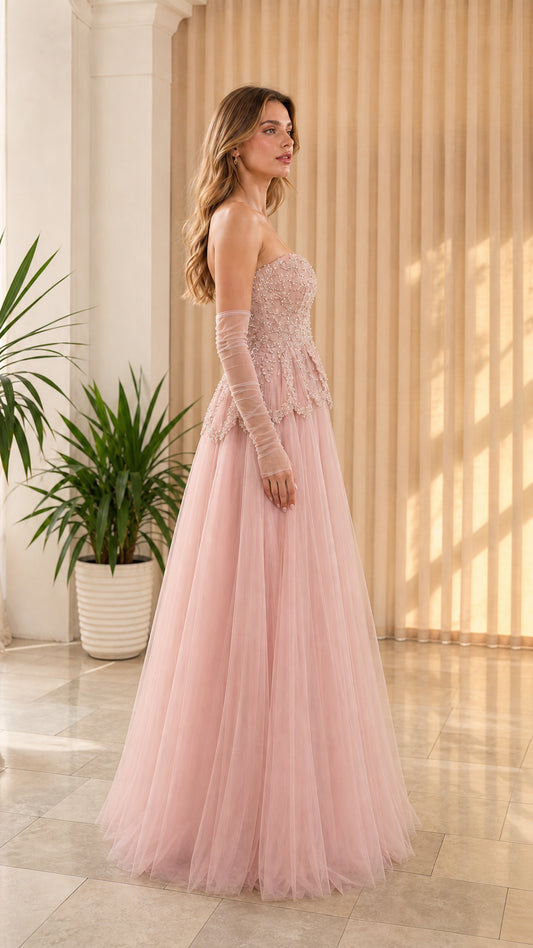 Side-front view of dusty pink strapless tulle formal dress with beaded corset top