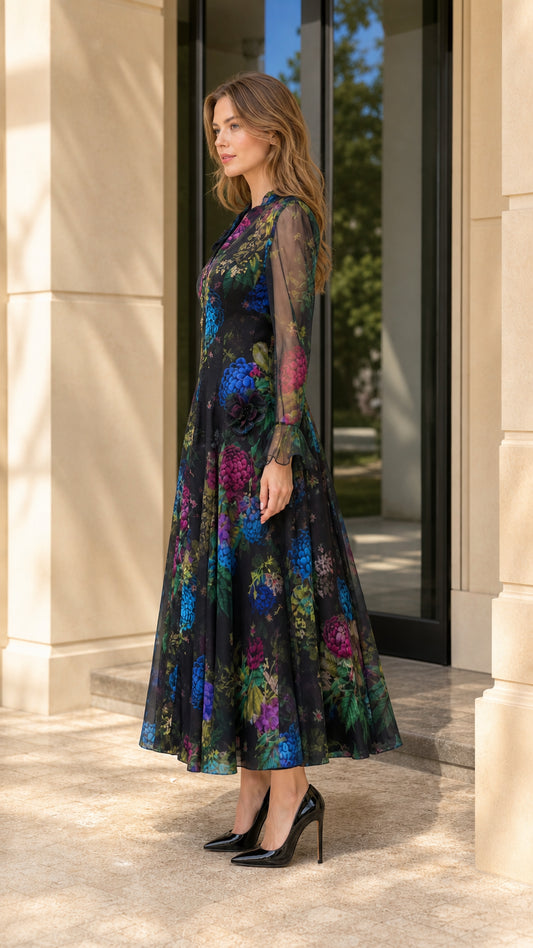 Side angle view of model wearing black floral print long sleeve evening dress
