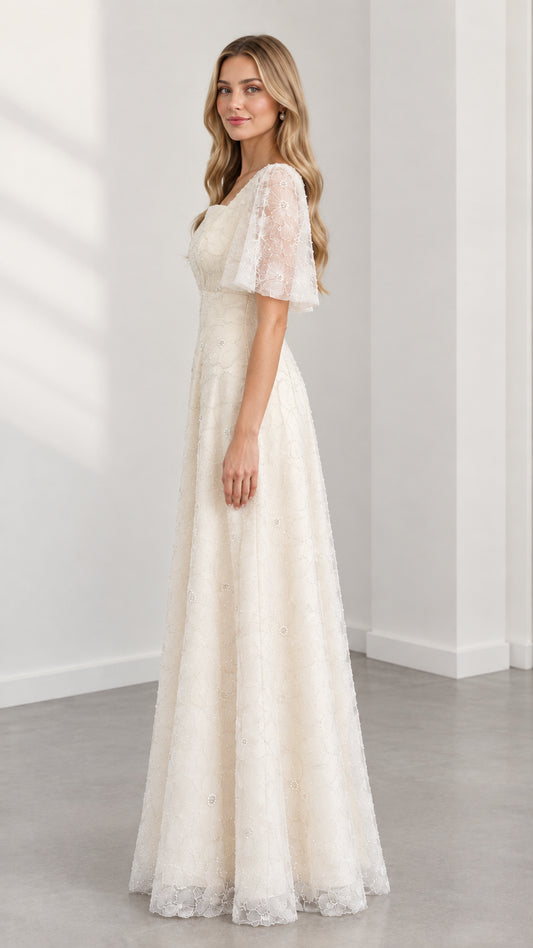 Side profile of cream embroidered lace A-line evening gown