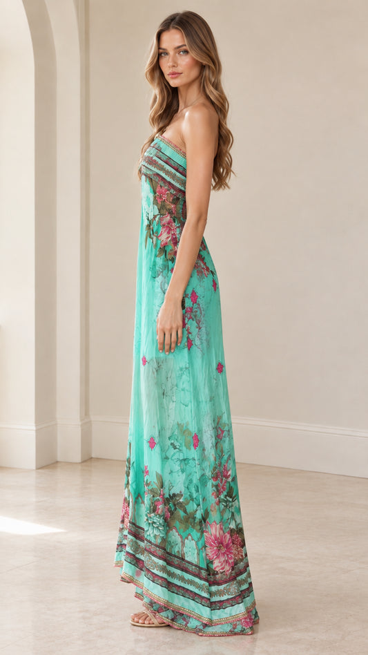 Side profile of woman wearing flowy turquoise strapless floral maxi gown