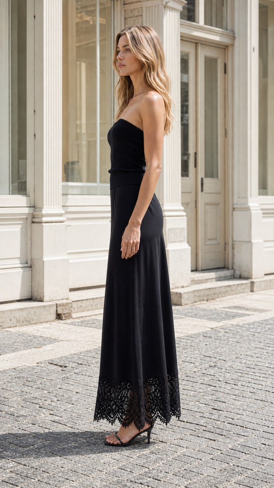 Side profile of woman in black strapless maxi dress
