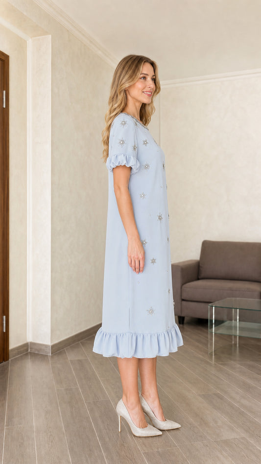 Model wearing light blue embellished midi dress, side view