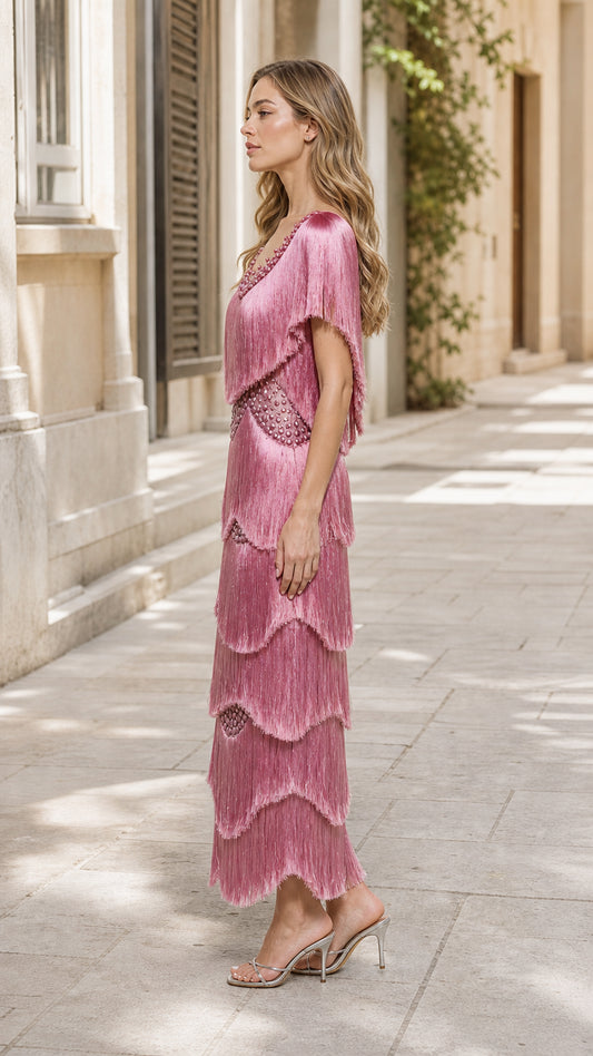 Side profile of model in pink fringe maxi dress