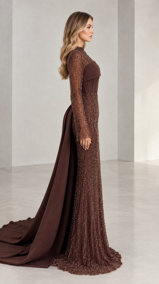 Side profile view of woman modeling brown beaded long sleeve formal gown with sweeping train