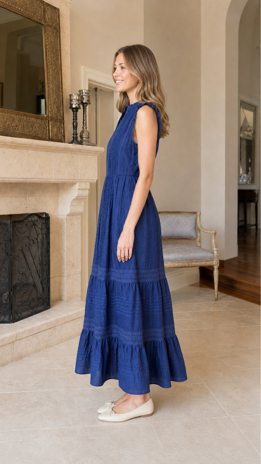 Side profile view of blue tiered midi dress