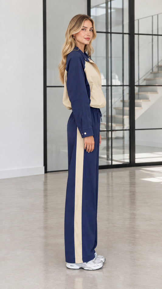 Side profile view of Navy Blue colorblock tracksuit showcasing wide leg stripe detail