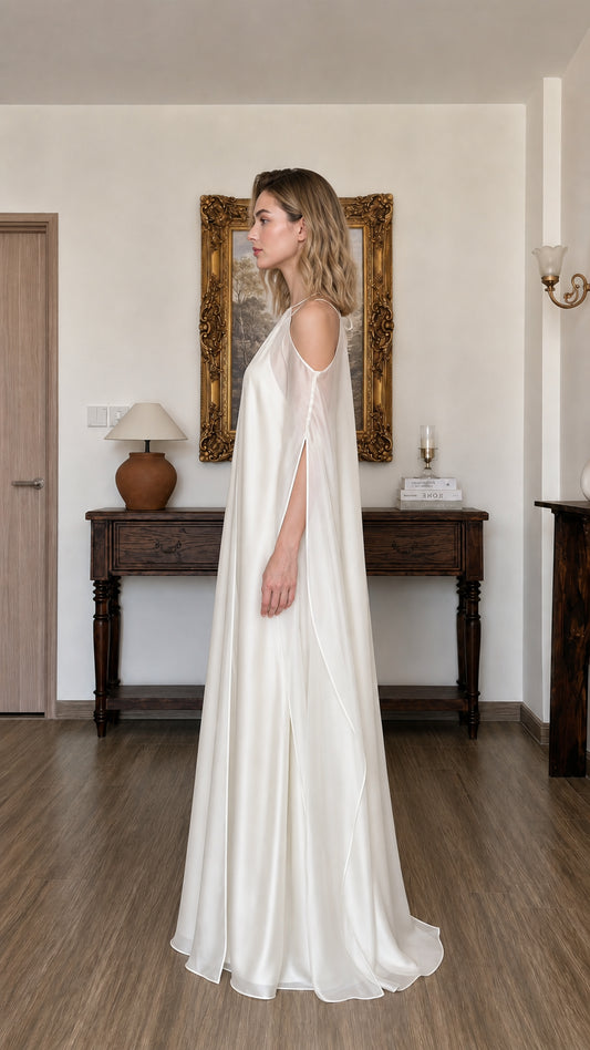 Side profile view of ivory maxi dress with draped sleeves