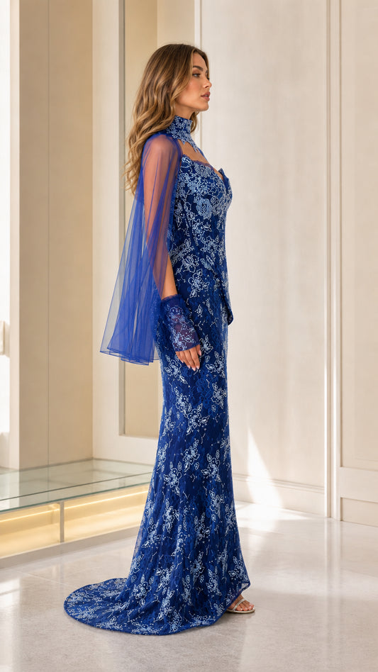 Side profile of royal blue formal gown with sheer cape