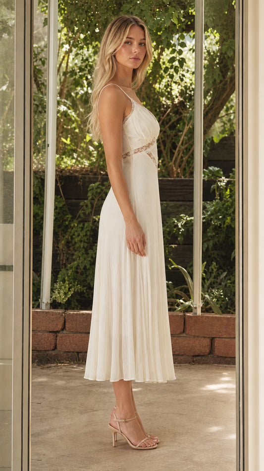 Side profile of model in white midi dress