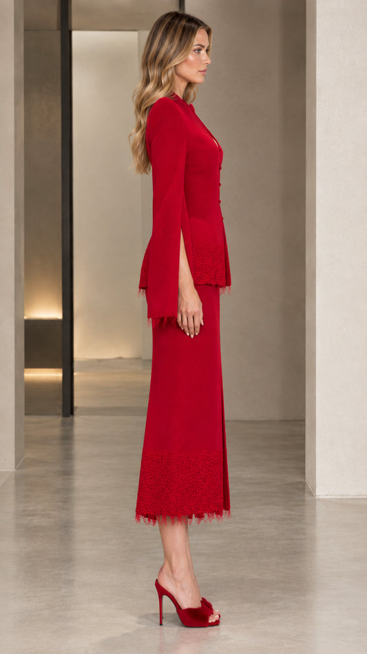 Side profile of the red tailored skirt suit showing sleeve slit and silhouette