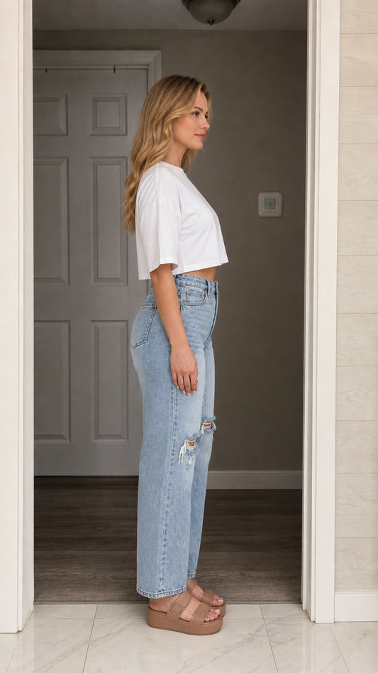 Model wearing white crop top, side profile view