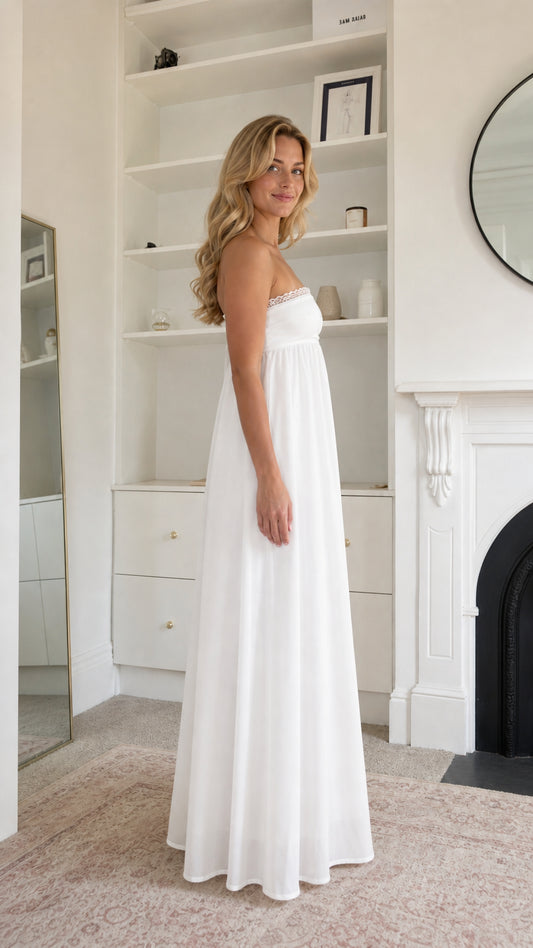 Side profile view of woman wearing white maxi dress