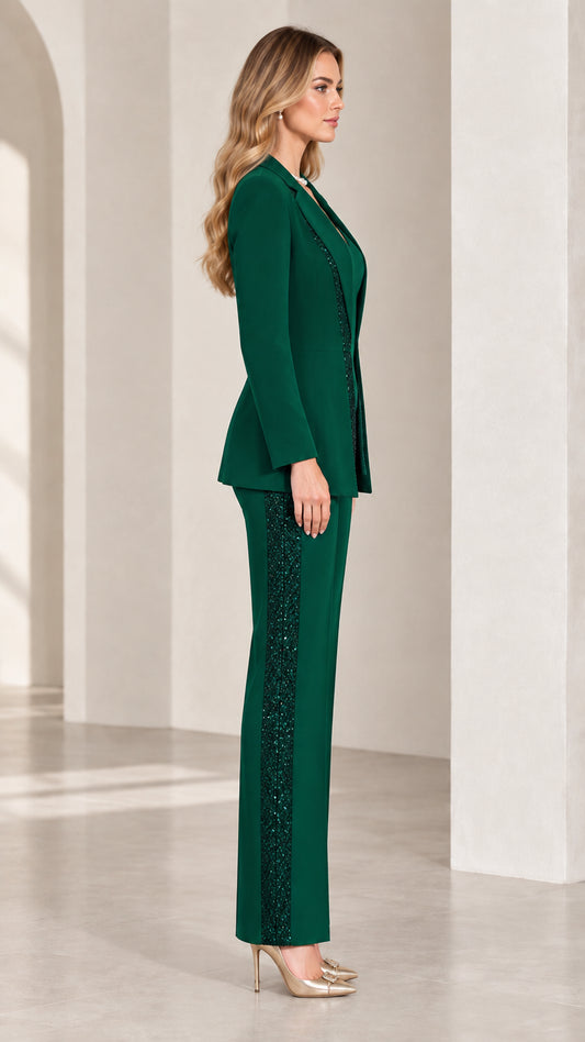 Side profile of woman in emerald green sequin embellished blazer and pants