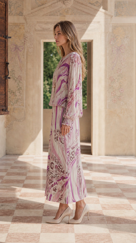 Side profile of model in pink abstract maxi dress