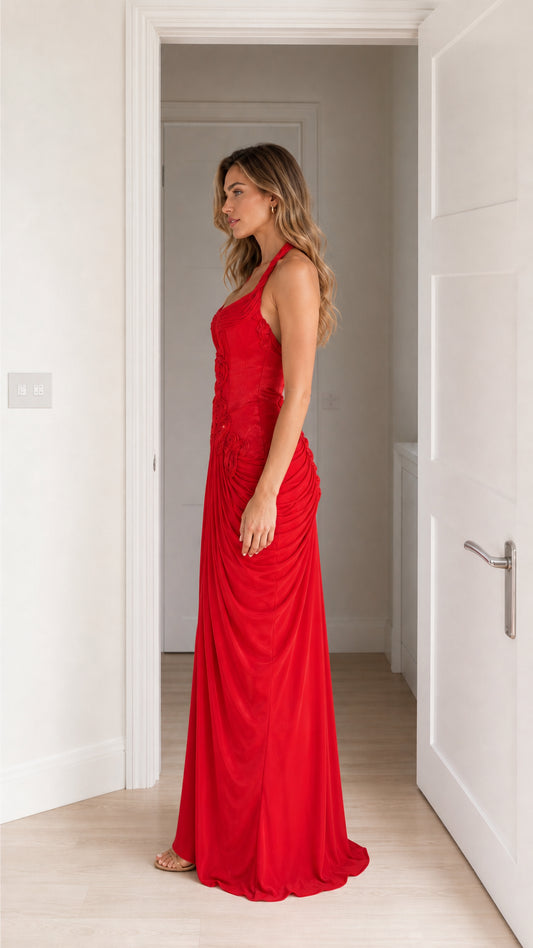 Side view of model in red halter neck maxi dress