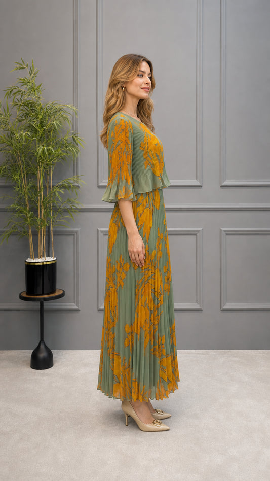 Side profile view of sage green floral pleated maxi dress showing sleeve and drape