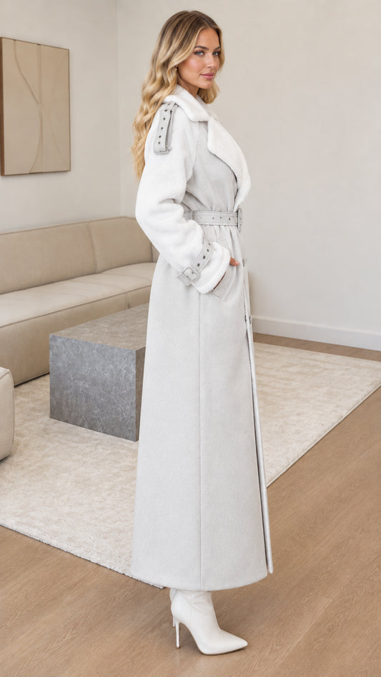 Side profile of woman in light grey longline shearling trench coat
