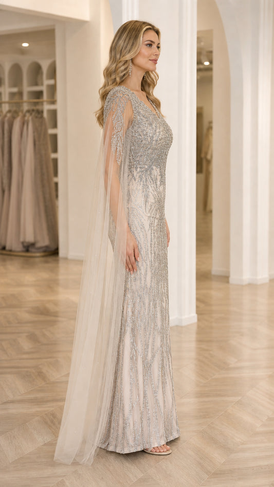 Side profile of Champagne Silver beaded evening dress showing floor-length flowing cape sleeves