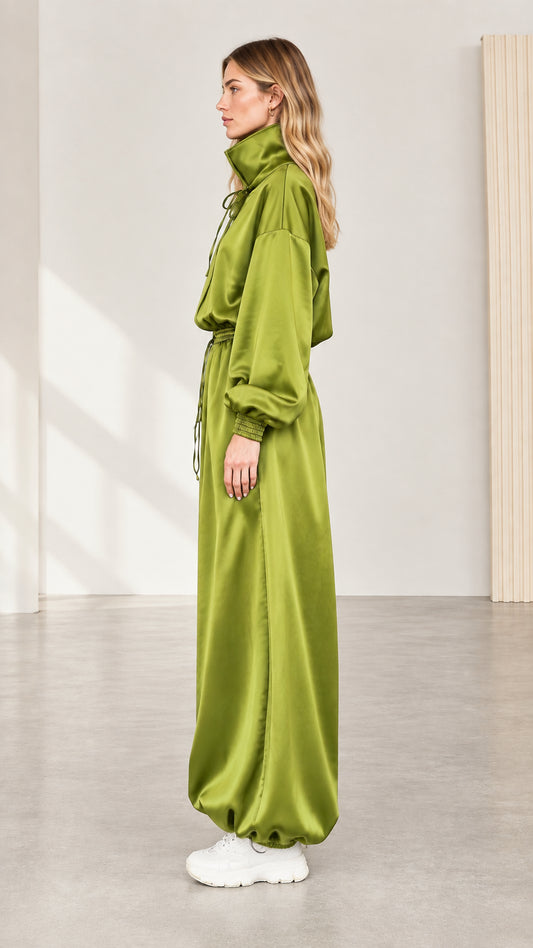 Side profile view of model in olive green satin drawstring jumpsuit