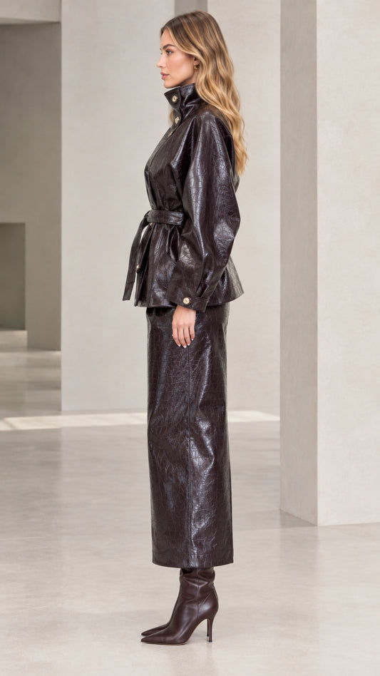 Side profile of woman in Dark Brown croc-embossed faux leather two-piece jacket and skirt set