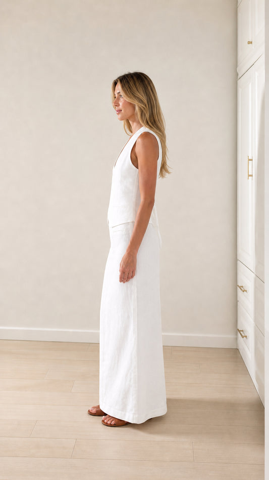 Side profile of woman wearing white vest and maxi skirt coordinates