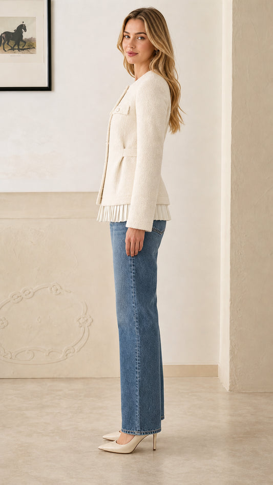Side profile of model in cream button-front tweed jacket with pleated trim