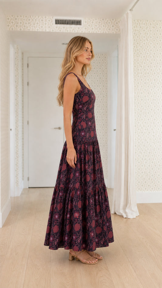 Side profile of model wearing plum floral sleeveless maxi dress