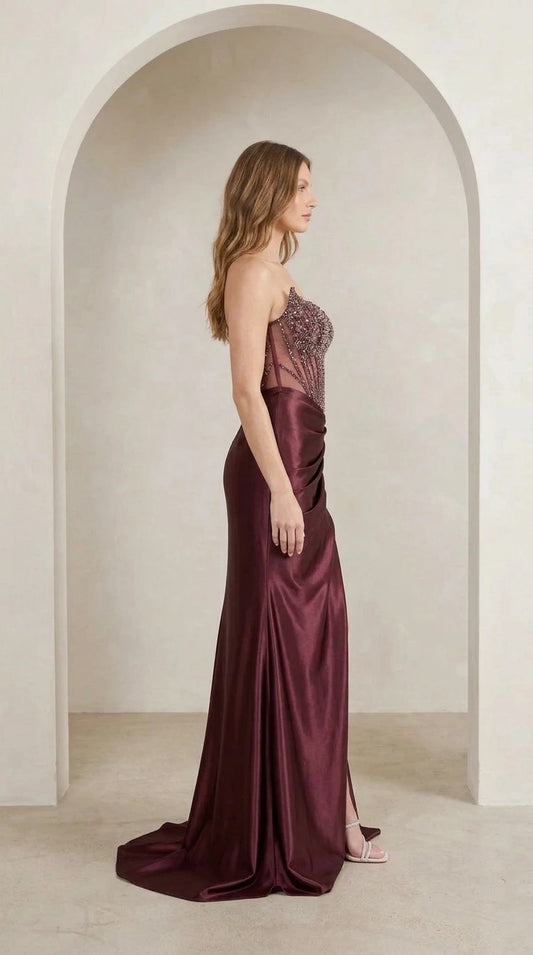 Model wearing burgundy evening gown side profile