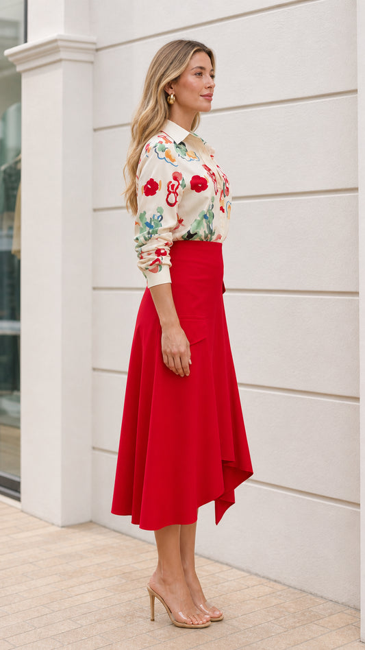 Model wearing cream floral button down shirt and red asymmetric midi skirt side view