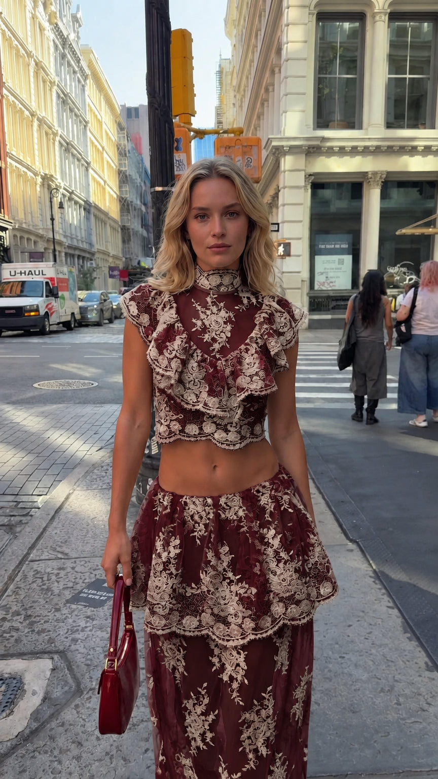 Model wearing burgundy floral lace crop top and tiered maxi skirt set