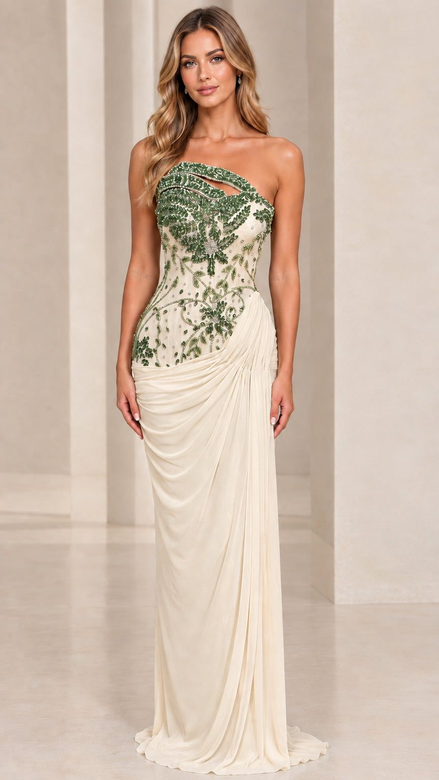 Front view of model wearing champagne cream gown with green embellished bodice