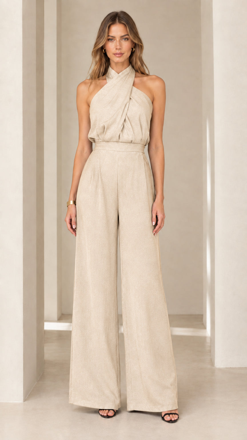 Model wearing beige cream crisscross halter neck wide-leg jumpsuit