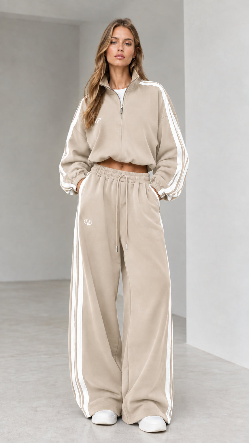 Front view of woman wearing beige cropped quarter-zip tracksuit set