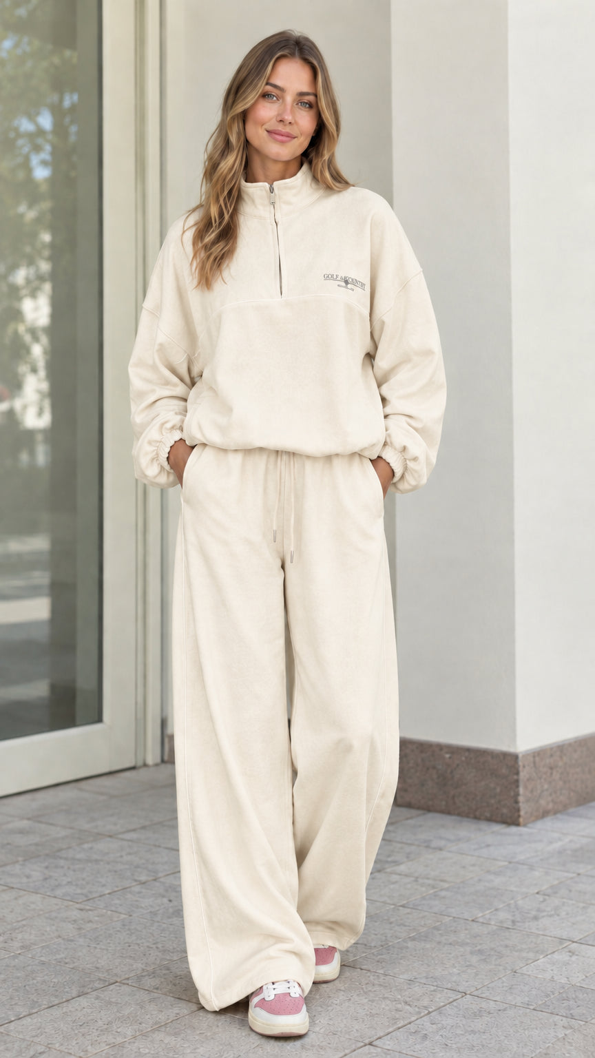 Woman wearing Cream off-white fleece quarter-zip pullover and wide-leg lounge set