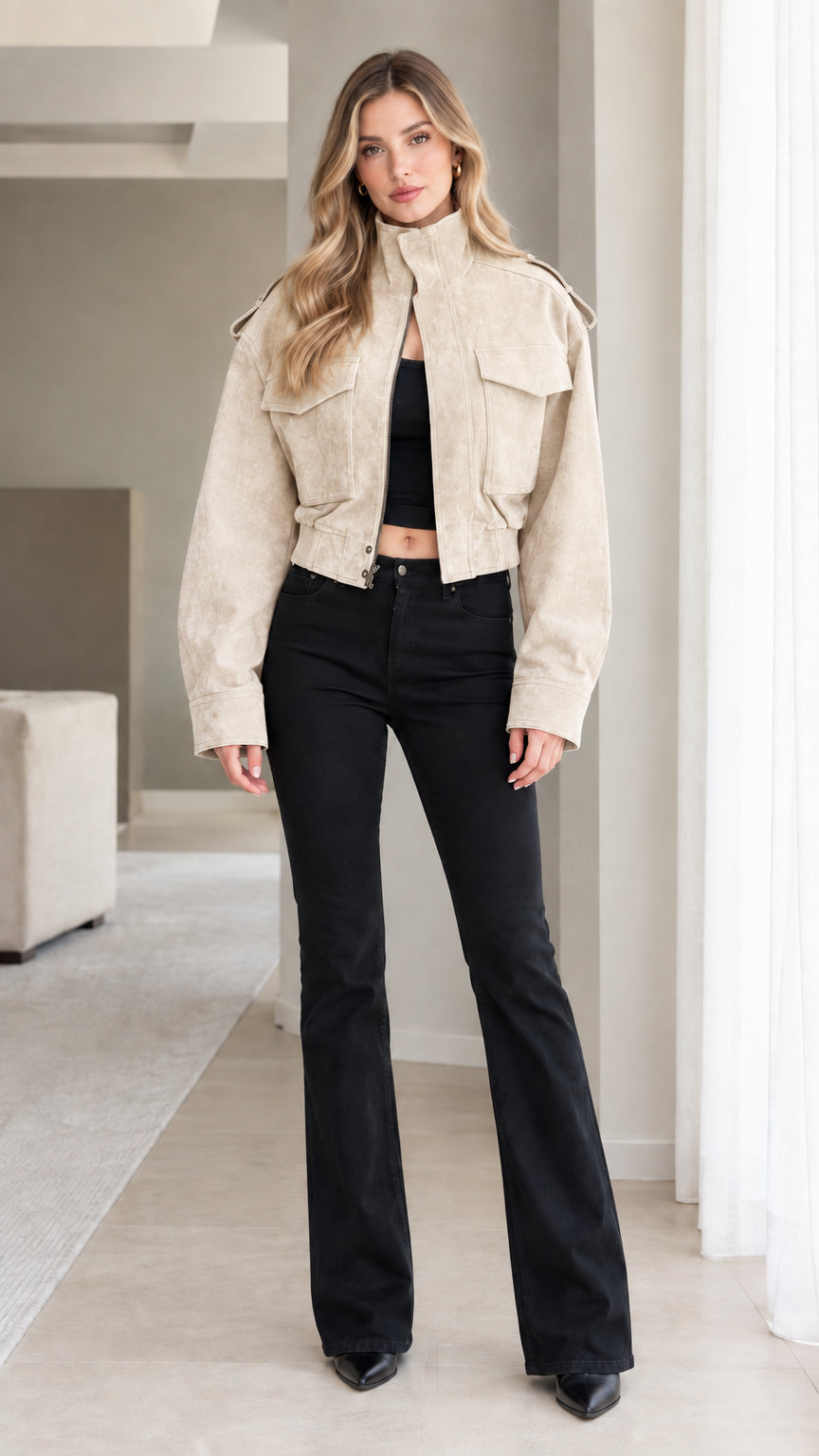 Model wearing Beige cropped faux suede utility jacket with flared black jeans