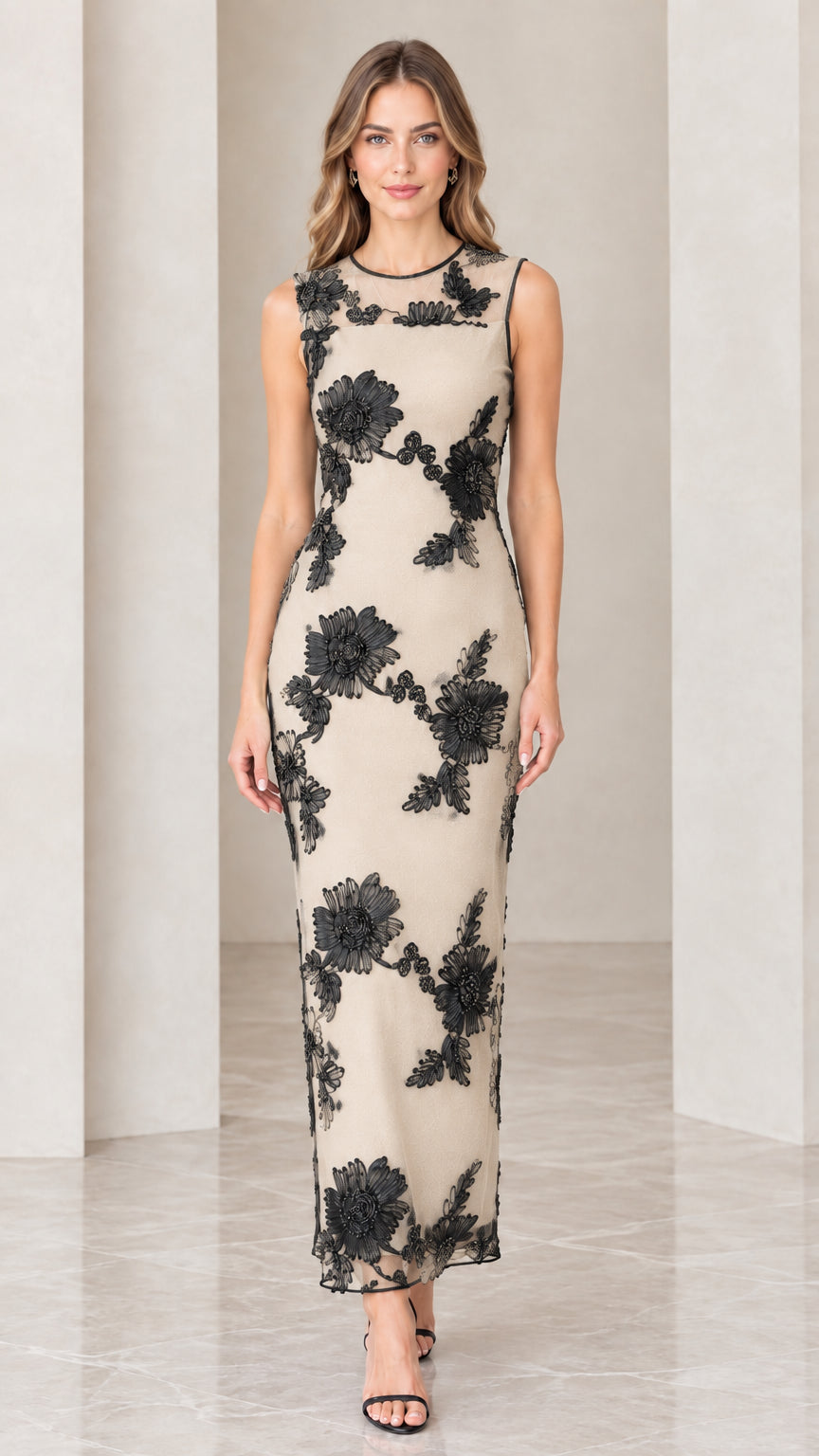 Model wearing champagne beige dress with contrast black floral appliqué