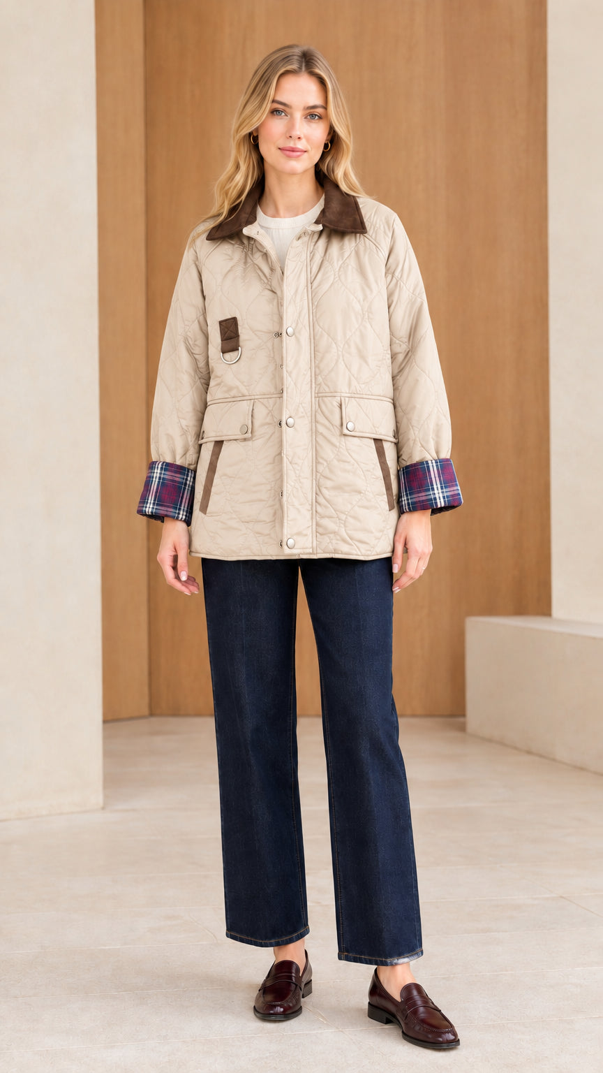 Front view of woman wearing beige sand quilted barn jacket with corduroy collar