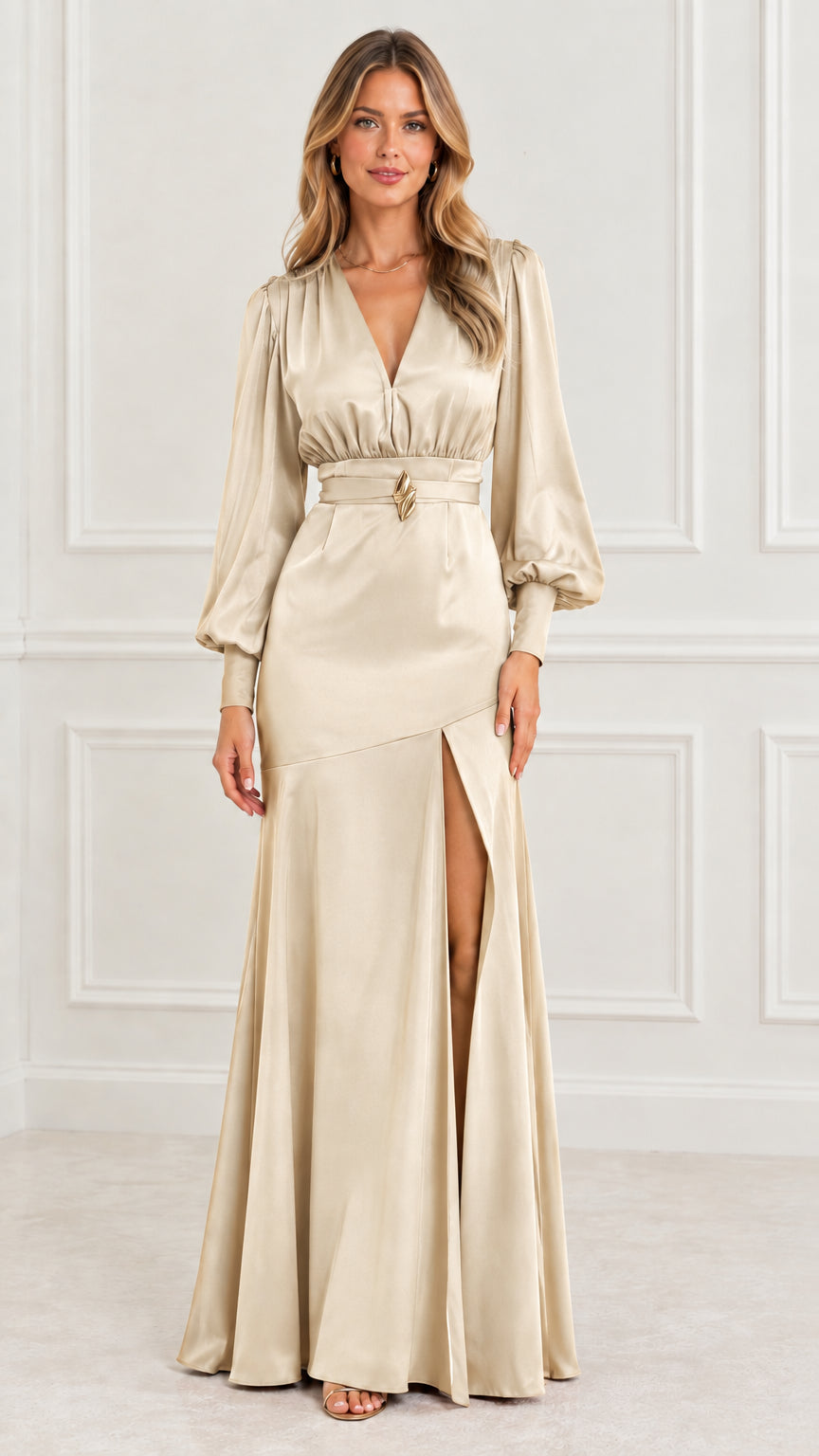 Full-length front view of model in champagne gold satin long sleeve maxi evening dress