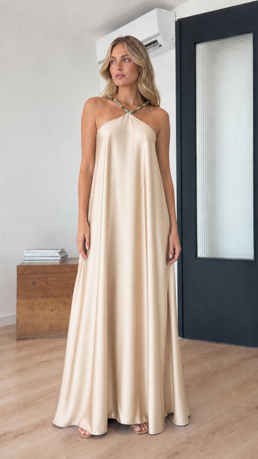 Model wearing champagne satin halter maxi dress