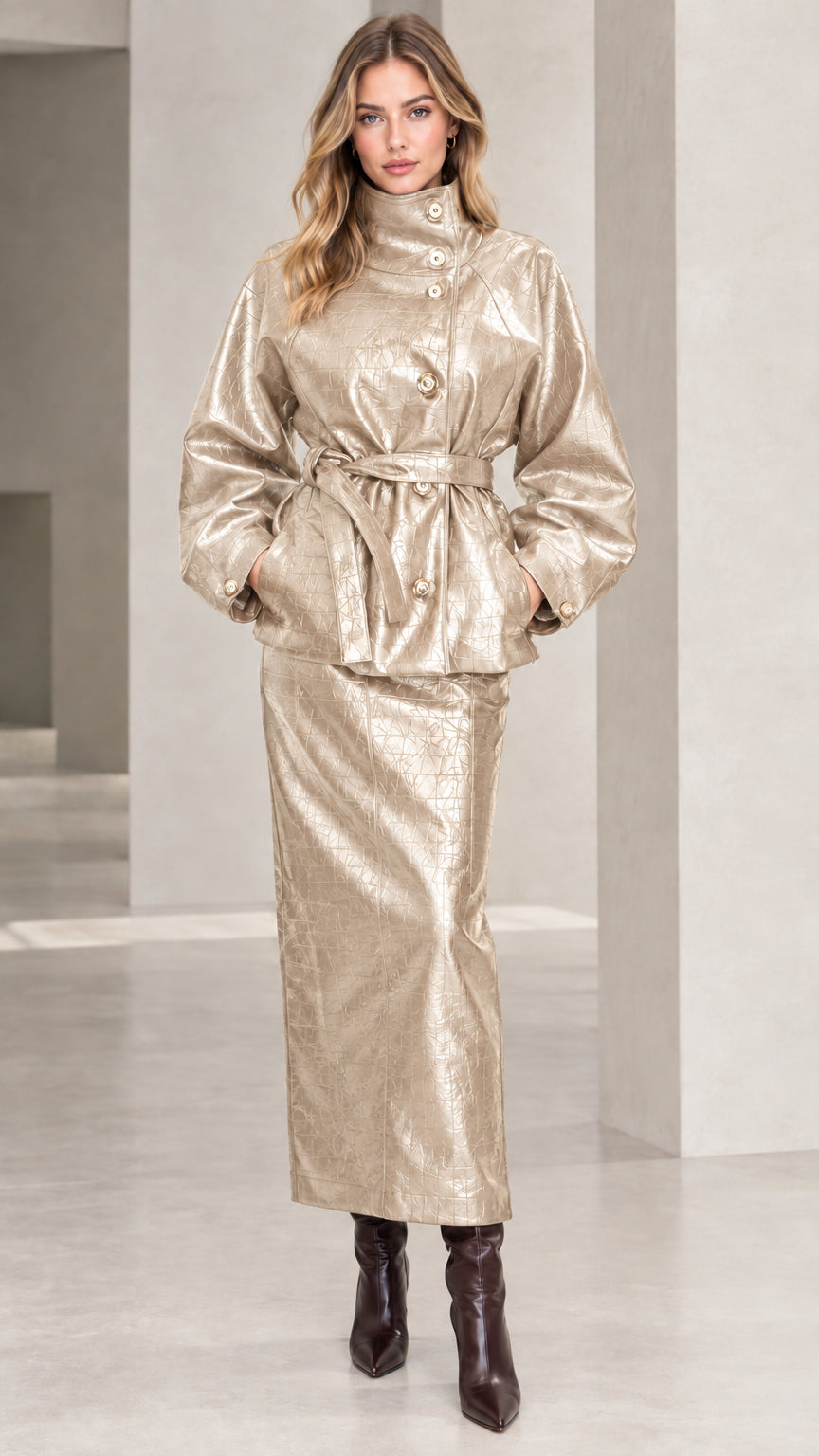Woman wearing Champagne Gold croc-embossed faux leather belted jacket and matching maxi skirt set