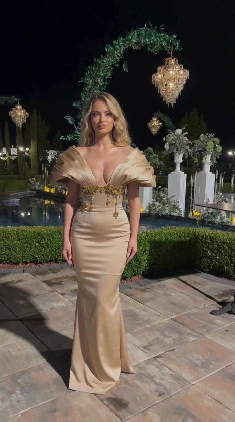 Full-length champagne gold mermaid formal gown with pleated bodice and beaded waist trim