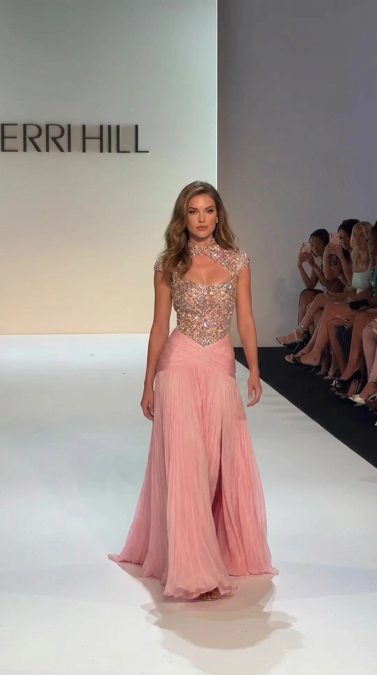 Front view of model wearing Blush Pink crystal beaded evening gown with pleated skirt