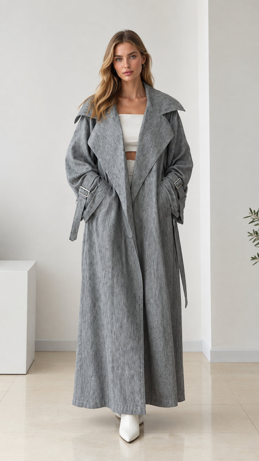 Full front view of women's oversized grey maxi trench coat with tie belt