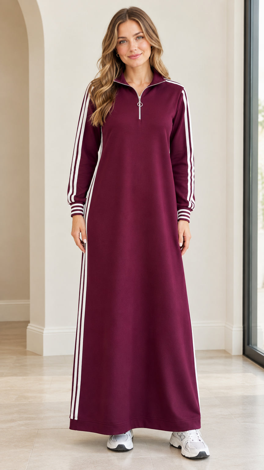 Front view of woman wearing burgundy half-zip striped sweatshirt maxi dress